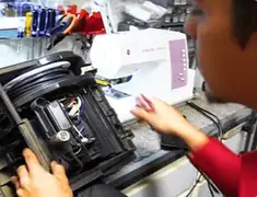 Vacuum repair technician servicing internal components on a workbench in Rockford, IL