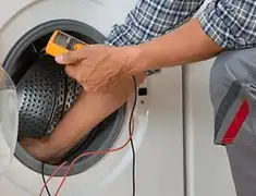 Washing machine repair technician testing a front-load washer with diagnostic tools in Rockford, IL